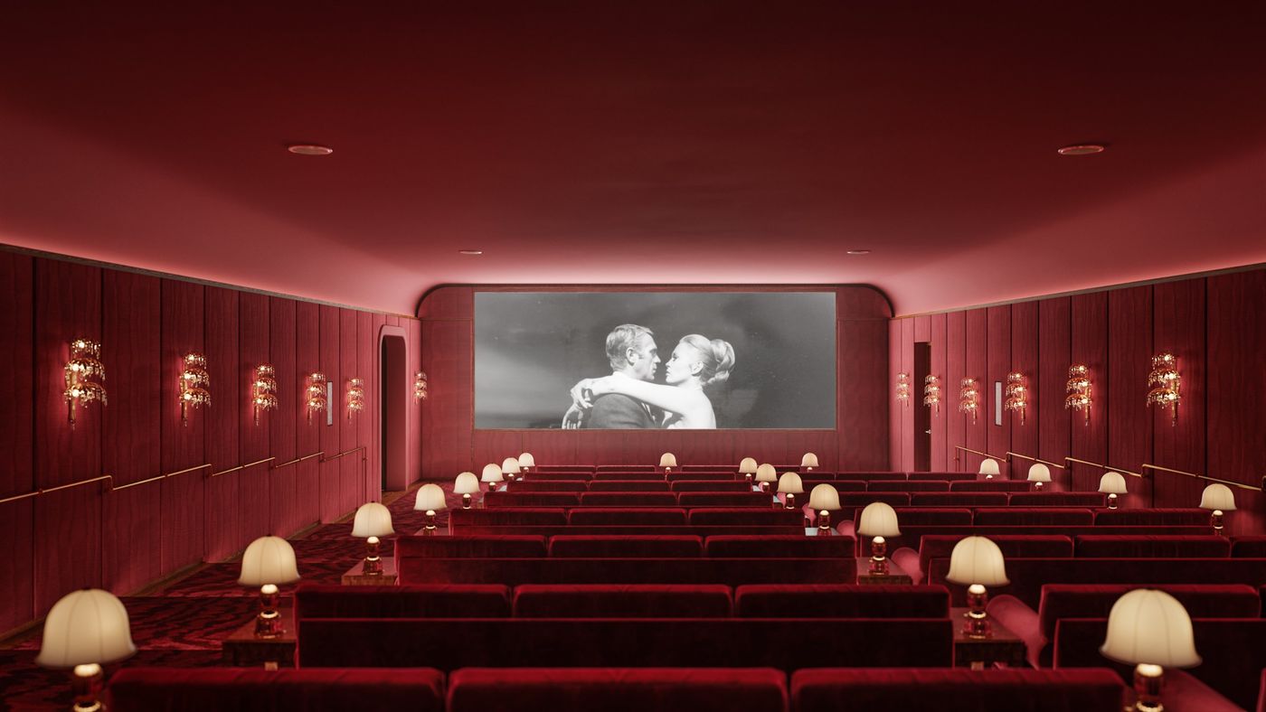 Red velvet screening room with table lamps between the rows
