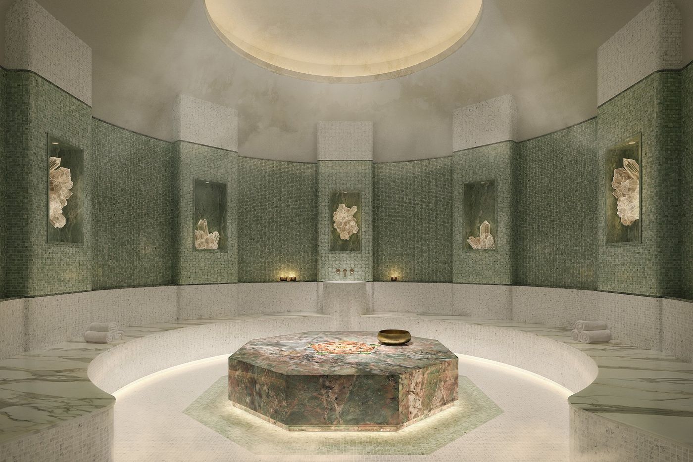 Domed hammam in green mosaic around a heated stone platform