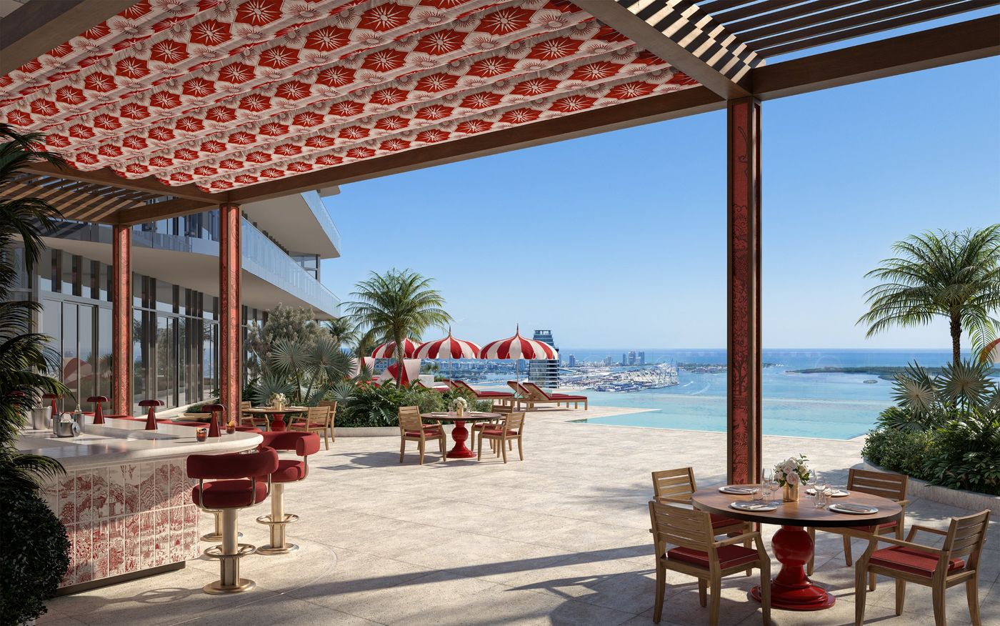 Red and white umbrellas and an outdoor bar over the bay