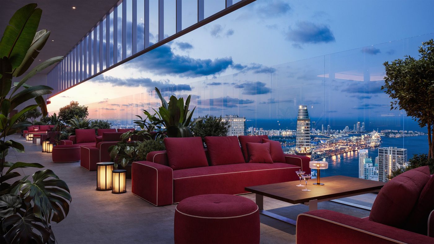Open-air lounge with red sofas and lanterns above the port